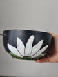 Black soup bowl with steel chopstick, white flower