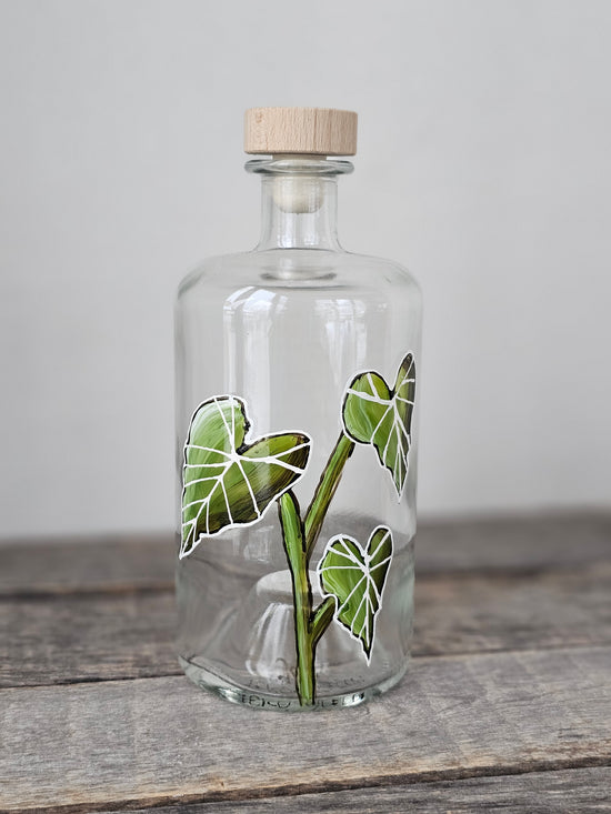 Recycled glass bottle with botanical design