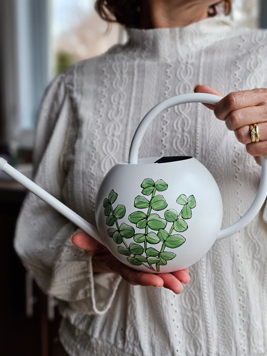 White metal watering can with eucalyptus design