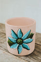 Small pink terracotta planter with turquoise flower design
