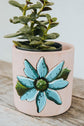 Small pink terracotta planter with turquoise flower design