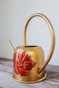 Golden metal watering can, white flower