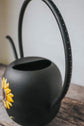 Black watering can sunflower design